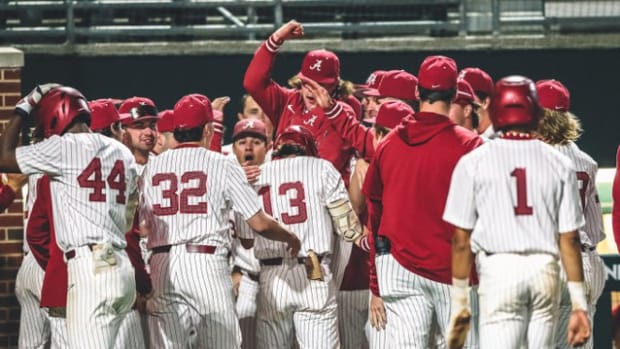 Alabama baseball celebrates a wild play that resulted in Bryce Eblin (13) scoring.